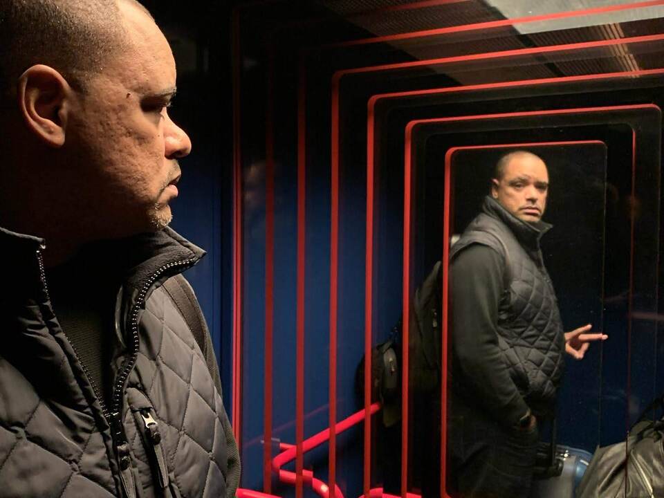 Man looking at himself in elevator mirror