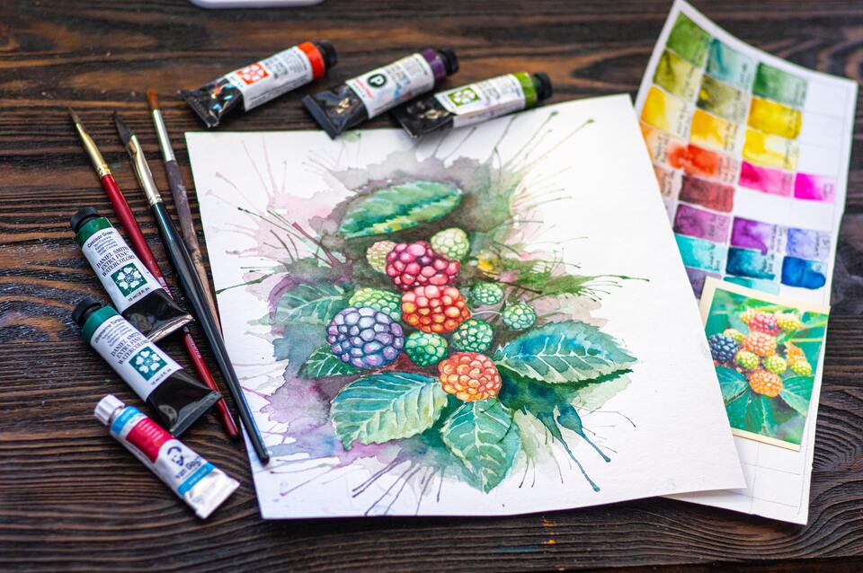 Painting of berries with paint tubes and brushes